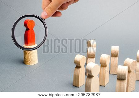 Magnifying Glass Is Looking At The Red Man Stands On The Podium And Appeals To The Crowd Of People. 