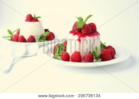 Panakota Dessert With Raspberries On A White Background Close-up.