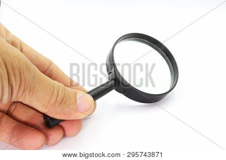 Hand Holding Magniflying Glass Isolated On White Background. High Resolution Image Gallery.