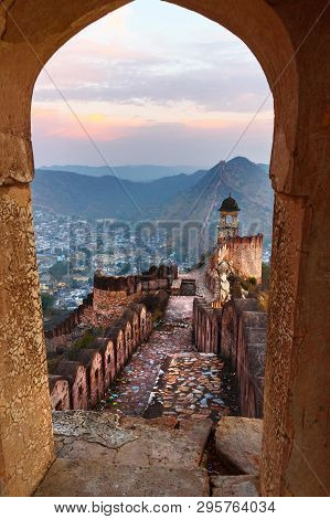 Ancient Long Wall With Towers Around Amber Fort Through The Arch Of Tower Walls At Morning. Jaipur. 