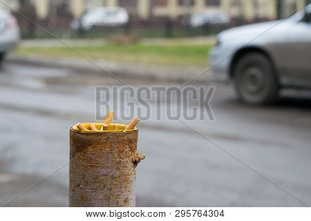 Cigarette Butts Are Stored In A Pipe Of A Column Protection For The Parking Which Is About The Road