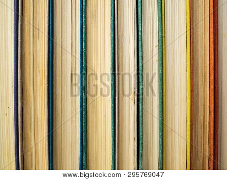 The Old Books Put In A Row. Several Books With The Grown Old Sheets. The Turned Yellow Pages Of Pape