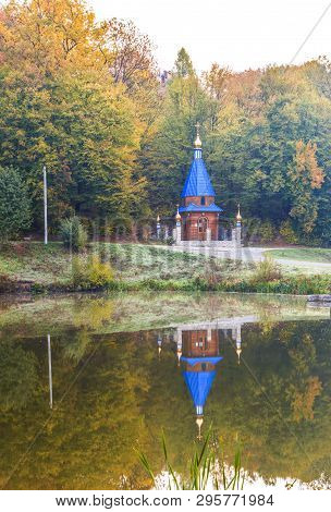 A Small Church On The Shore Of A Lake In The Autumn Forest Of Tovtry Reserve, Khmelnitsky Region, Uk