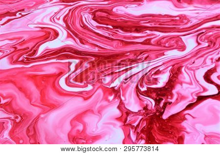 Red Paint Freely Mixed With White. Abstract Artistic Texture. Acrylic Paint And Liquid Inks Are Mixe
