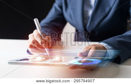 Businessman Hands Using Tablet Computer. Digital Marketing Media Or Financial Diagrams In Virtual Sc