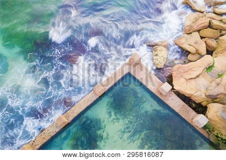 Mciver Ocean Baths At Coogee Top Down View With Swirling Ocean Waves Against The Rocks And Pool Wall