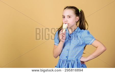 Taste A Little. Cute Little Girl Enjoy Sweet Taste Of Frozen Dessert. Small Child Licking Ice Cream 