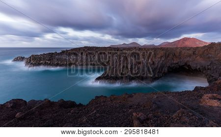 A Long Exposure Of The Sea At The Shore Of Lanzarote After The Sunset. This Part Of The Shore Is Cal