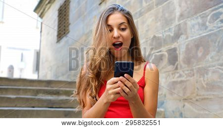 Banner Crop For Advertising Copy Space, Background European Old Town Stone Wall. Smiling Woman Using