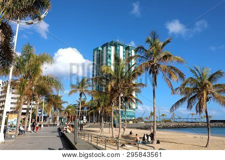 Lanzarote, Spain - April 20, 2018: Beach And Palm Trees In Front Of Five Stars Hotel In Arrecife Wit