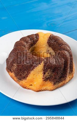Kuglof On The White Plate And Blue Background