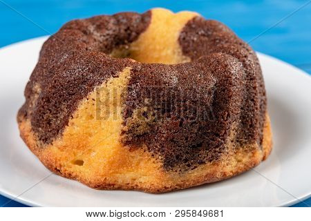 Kuglof On The White Plate And Blue Background