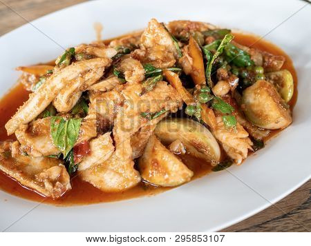 Thai​ Hot And Spicy Stir-fried Fish With Local Ingredients; Red Chilli Paste, Pepercorn, Basil Leaf,
