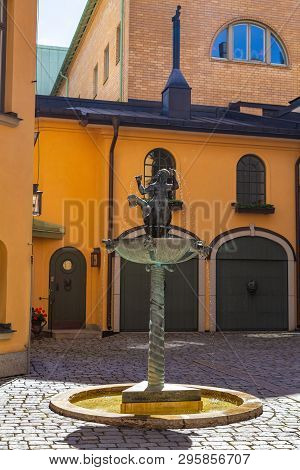 Orebro, Sweden - July, 2016: Small Fountain With The Figure Of A Mermaid In The City Courtyard.
