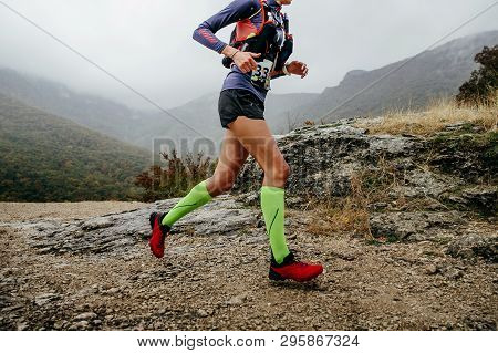 Woman Runner Run Mountain Race With Trail Vest For Running