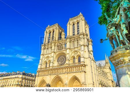 French Architecture Of Notre Dame Cathedral Of Paris, France. Beautiful Sunny Day In The Blue Sky. O