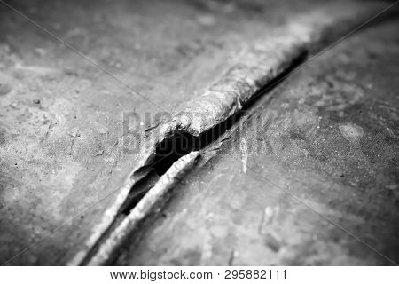 Defect - A Crack In The Pipeline Pipe. Photographed In Ukraine. Kiev Region. Horizontal Frame. Black