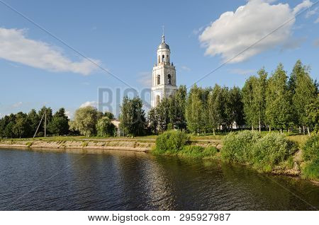 Riverbank With Old Bell Tower In Poshekhonye, Yaroslavl Region, Russia. Sunny Summer Day.