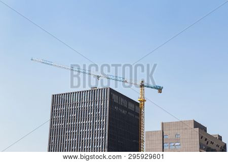 Construction Site Background. Hoisting Cranes And New Multi-storey Buildings. I.ndustrial Background