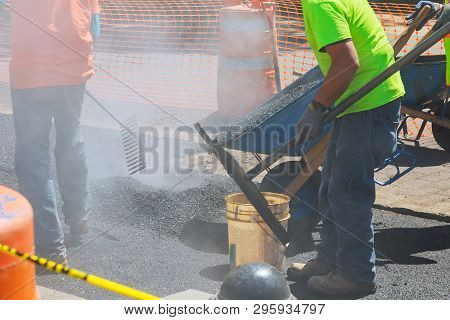 Workers On A Industry Aying Fresh Asphalt Bitumen During Road Construction