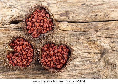 Annatto Seeds On Rustic Wood