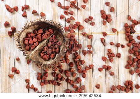 Annatto Seeds On Rustic Wood