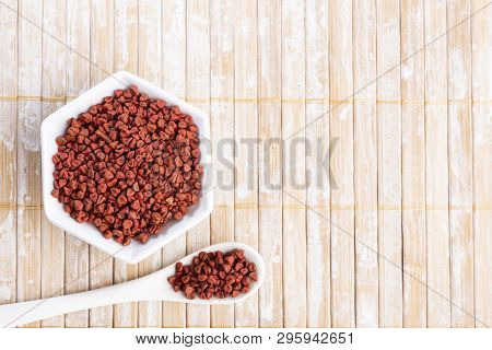 Annatto Seeds On Rustic Wood