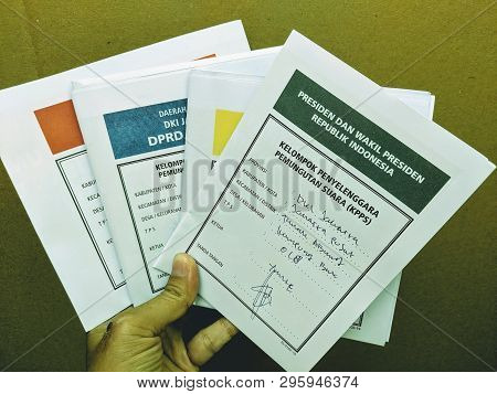 Jakarta, Indonesia - April 17, 2019: A Female Hand Holding Four Ballots To Cast A Vote In Indonesia 