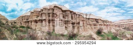 Panoramic View Of The Bizzare Rock In Goreme Village, Turkey. Rural Cappadocia Landscape. Volcanic M