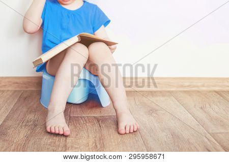 Funny Child Boy Sitting On Chamberpot, Childrens Legs Hanging Down From A Pot
