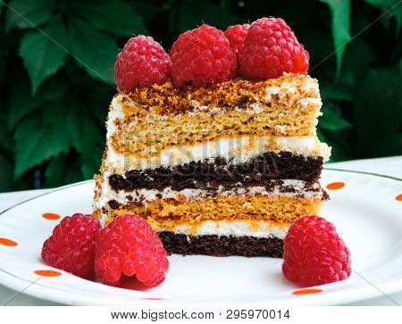 A Small Piece Of Fresh Cake With Red Raspberries. Dessert For Tea. Raspberry Cake And Many Fresh Ras