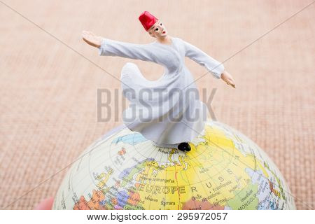 Swirling Dervish On A Globe On A Textured Background