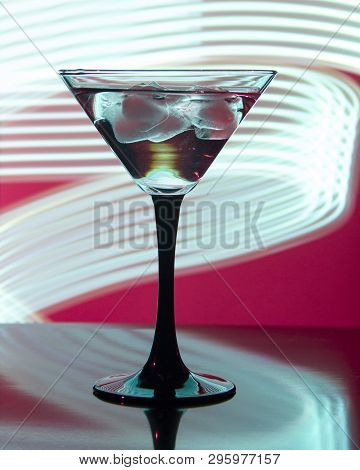 Glass With Cocktail And Ice On A Beautiful Background With Neon Stains