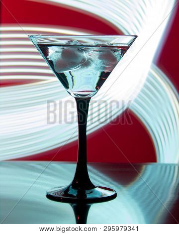 Glass With Cocktail And Ice On A Beautiful Background With Neon Stains