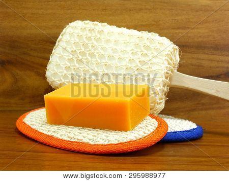 Natural Luff Sponge With Orange Soap On Wooden Background