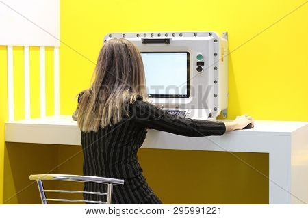 The Girl Operator Is Sitting Behind An Explosion-proof Monitor At A Refinery. Explosion-proof Comput