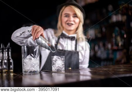 Pretty Woman Bartender Places The Finishing Touches On A Drink While Standing Near The Bar Counter I