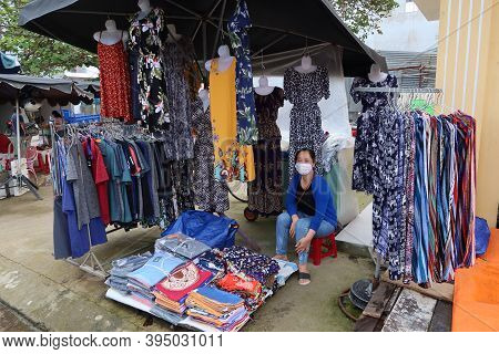 Hoi An, Vietnam, November 16, 2020: A Woman At Her Stall Selling Clothes On One Of The Streets In Th