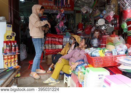 Hoi An, Vietnam, November 16, 2020: Three Women At The Entrance Of A Shop In The Ba Le Market In Hoi