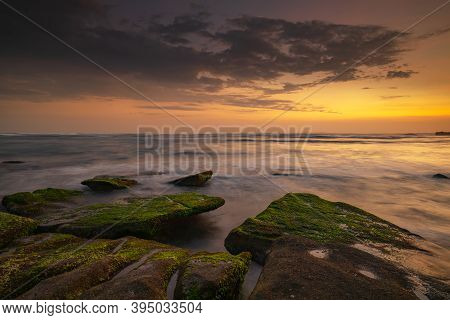 Calm Ocean Long Exposure. Stones Covered By Geen Moss In Mysterious Mist Of The Sea Waves. Concept O