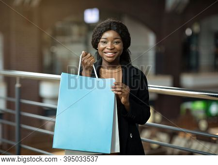 Yes, I Bought It. Happy Young African American Lady Shows Colored Paper Bags With Purchases And Glad