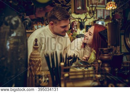 Parrot. Smiling Family, Caucasian Couple Looking For Home Decoration And Holidays Gifts In Household