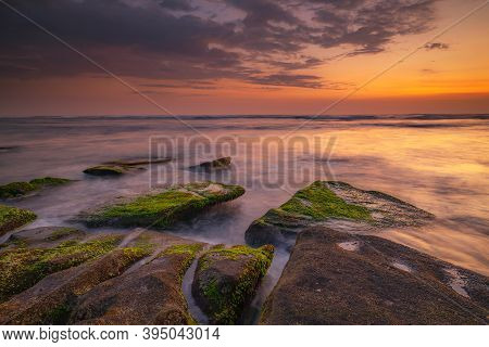 Calm Ocean Long Exposure. Stones Covered By Geen Moss In Mysterious Mist Of The Sea Waves. Concept O