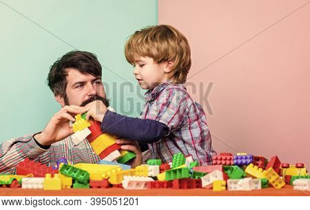 Child Care Development And Upbringing. Father Son Game. Father And Son Create Constructions. Bearded