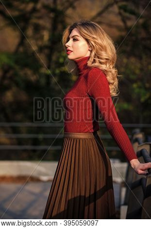 Feeling Free And Relaxed. Girl Long Blond Hair City Walk. Autumn Woman Curly Hair Outdoor. Haidresse