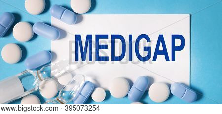Medigap, Text On White Paper On Blue Background. Medical Concept.