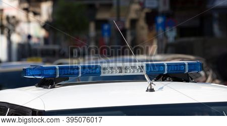 Blue Light Flasher At Police Car Top, Defocused City Street Background