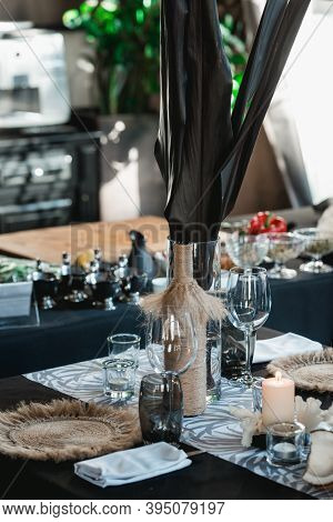 Served Tables For Wedding Banquet With Plates Restaurant. Decor From Fresh Flowers, Coconuts And Lea