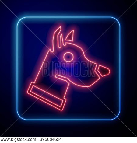 Glowing Neon Dog Head Icon Isolated On Blue Background. Vector