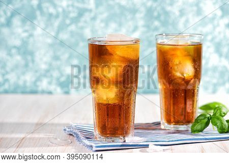 The Glass Of Iced Tea On Wooden Table. Cuba Libre Or Long Island Cocktail